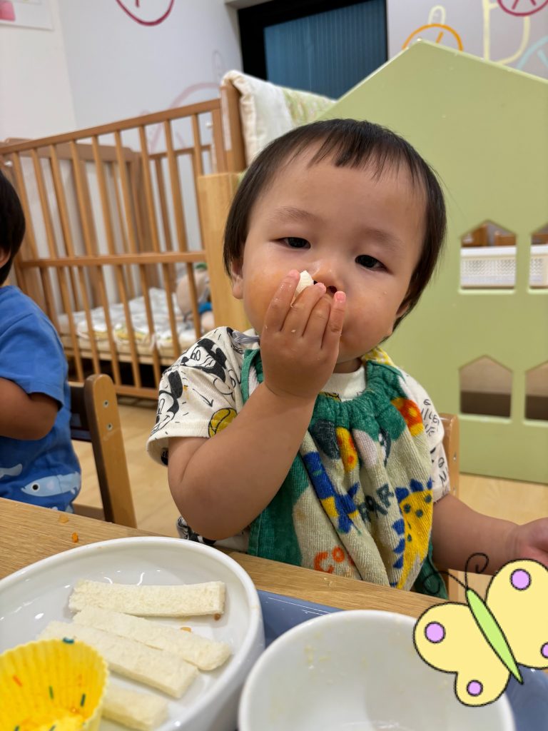 手づかみで給食を食べる園児