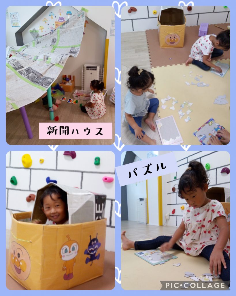 新聞紙で屋根を作った園児たちとパズルをする園児